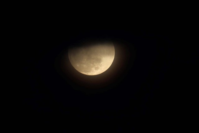 A blue moon rises through clouds in San Diego, California, U.S., January 30, 2018. REUTERS/Mike Blake