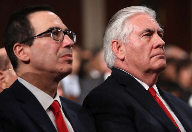 Treasury Secretary Steven Mnuchin (L) and U.S. Secretary of State Rex Tillerson listen during U.S. President Donald Trump's first State of the Union address to a joint session of Congress on Capitol Hill in Washington, U.S., January 30, 2018. REUTERS/Win McNamee/Pool