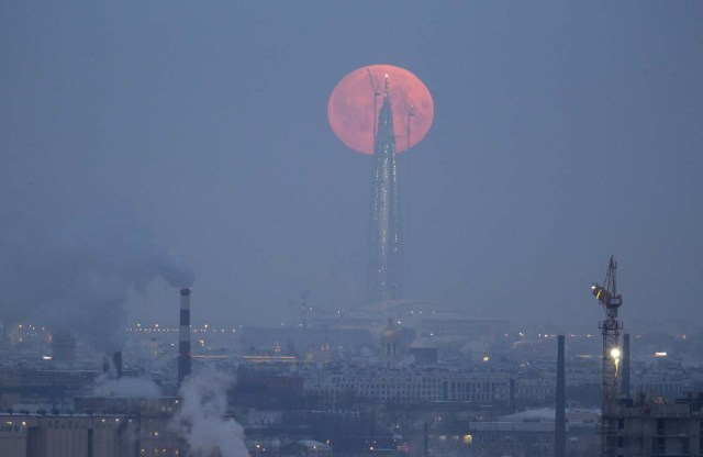 A full moon is seen behind the business tower Lakhta Centre, which is under construction in St. Petersburg, Russia January 31, 2018. REUTERS/Anton Vaganov TPX IMAGES OF THE DAY