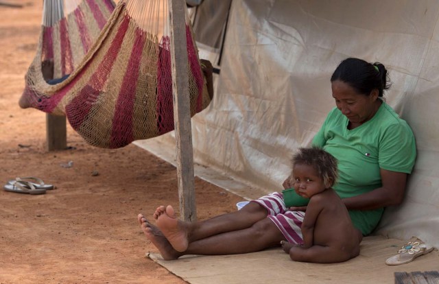 A Venezuelan indigenous refugee mother and son rest inside a shelter in the city of Boa Vista, Roraima, Brazil, on February 24, 2018. According with local authorities, around one thousand refugees are crossing the Brazilian border each day from Venezuela. With the constant influx of Venezuelan immigrants most are living in shelters and the streets of Boa Vista and Paracaima cities, looking for work, medical care and food. Most are legalizing their status to stay and live in Brazil. / AFP PHOTO / MAURO PIMENTEL