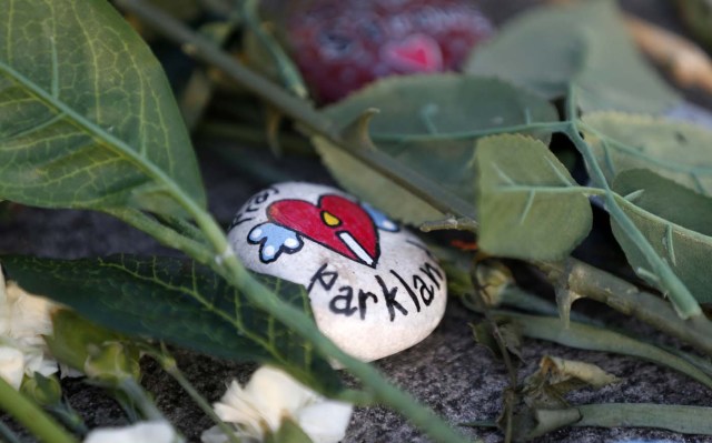 A painted rock sits outside one of the makeshift memorials at Marjory Stoneman Douglas High School in Parkland, Florida on February 27, 2018. Florida's Marjory Stoneman Douglas high school will reopen on February 28, 2018 two weeks after 17 people were killed in a shooting by former student, Nikolas Cruz, leaving 17 people dead and 15 injured on February 14, 2018. / AFP PHOTO / RHONA WISE