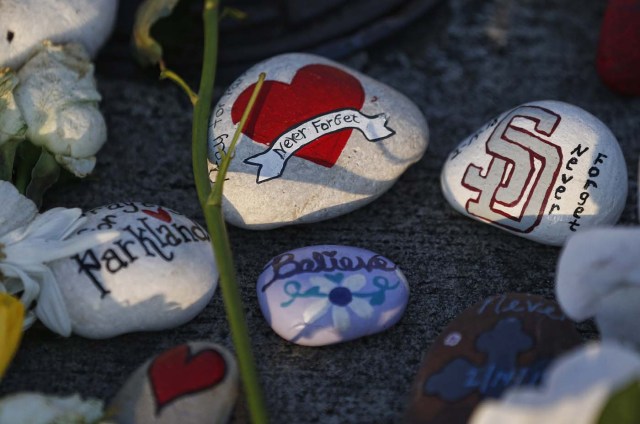 A painted rock sits outside one of the makeshift memorials at Marjory Stoneman Douglas High School in Parkland, Florida on February 27, 2018. Florida's Marjory Stoneman Douglas high school will reopen on February 28, 2018 two weeks after 17 people were killed in a shooting by former student, Nikolas Cruz, leaving 17 people dead and 15 injured on February 14, 2018. / AFP PHOTO / RHONA WISE