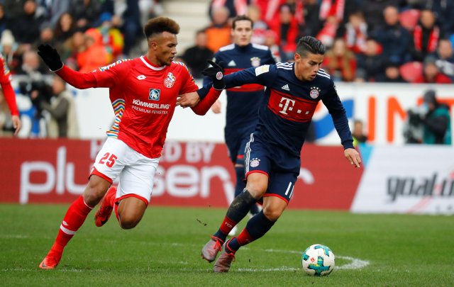 Soccer Football - Bundesliga - 1.FSV Mainz 05 vs Bayern Munich - Opel Arena, Mainz, Germany - February 3, 2018 Bayern Munich's James Rodriguez in action with Mainz’s Jean-Philippe Gbamin REUTERS/Kai Pfaffenbach DFL RULES TO LIMIT THE ONLINE USAGE DURING MATCH TIME TO 15 PICTURES PER GAME. IMAGE SEQUENCES TO SIMULATE VIDEO IS NOT ALLOWED AT ANY TIME. FOR FURTHER QUERIES PLEASE CONTACT DFL DIRECTLY AT + 49 69 650050