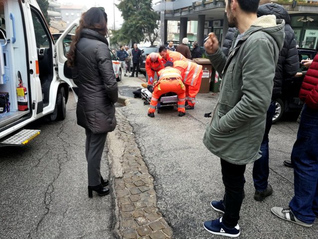 Healthcare personnel take care of an injured person after being shot by gun fire from a vehicle, in Macerata, Italy, February 3, 2018. REUTERS/Stringer NO RESALES NO ARCHIVE