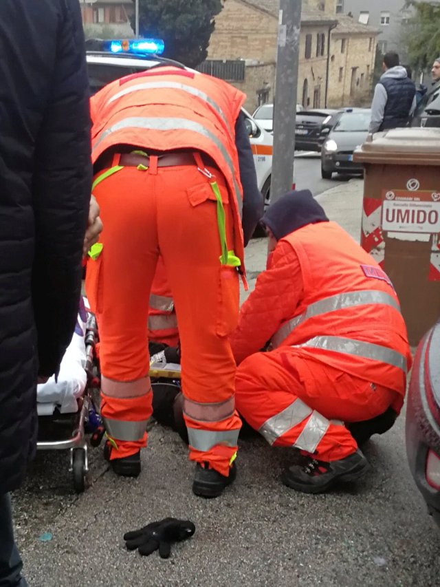 Healthcare personnel take care of an injured person after being shot by gun fire from a vehicle in Macerata, Italy, February 3, 2018. REUTERS/Stringer NO RESALES NO ARCHIVE