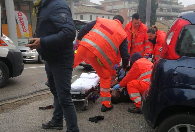 ATTENTION EDITORS - VISUAL COVERAGE OF SCENES OF INJURY OR DEATH Healthcare personnel take care of an injured person after being shot by gun fire from a vehicle in Macerata, Italy, February 3, 2018. REUTERS/Stringer NO RESALES NO ARCHIVE TEMPLATE OUT