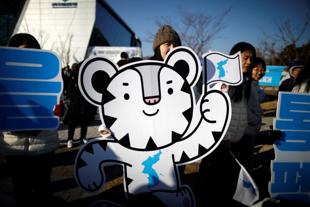 The 2018 PyeongChang Winter Olympics mascot Soohorang is seen as South Korean supporters cheer for the inter-Korean women's ice hockey athletes before their friendly match against Sweden in Incheon, South Korea, February 4, 2018. REUTERS/Kim Hong-Ji