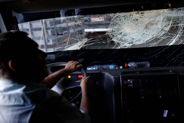 Andres Pernia drives his truck with a broken windshield as he arrives to check the tires in a shop in La Grita, Venezuela January 29, 2018. The windshield was broken a month ago when someone threw a stone at the truck while it was driving. REUTERS/Carlos Garcia Rawlins SEARCH "LAWLESS ROADS" FOR THIS STORY. SEARCH "WIDER IMAGE" FOR ALL STORIES.?