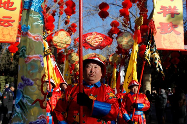 Performers take part in the re-enactment of a Qing Dynasty ceremony, in which emperors prayed for good harvest and fortune for the Chinese New Year, during the Spring Festival Temple Fair at the Temple of Earth in Ditan Park in Beijing, China, February 16, 2018. REUTERS/Thomas Peter