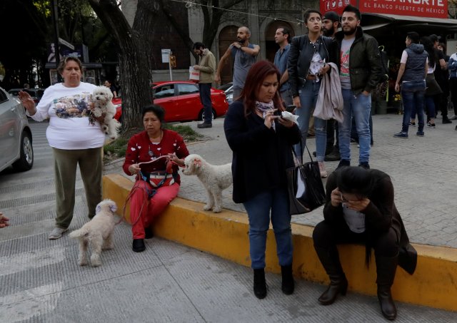 People wait outside their homes after a tremor was felt in Mexico City, Mexico February 16, 2018. REUTERS/Henry Romero