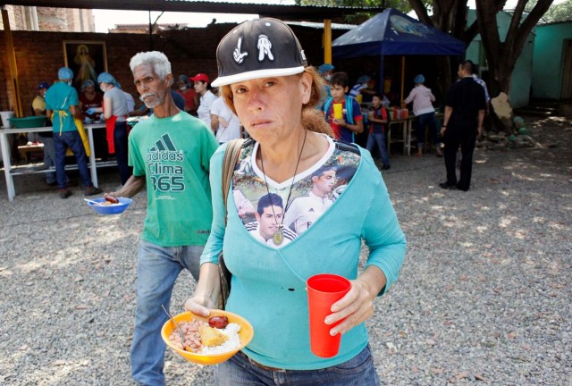 A woman from Venezuela holds a plate with food at a dining facility organised by Caritas and the Catholic church, in Cucuta, Colombia February 21, 2018. Picture taken February 21, 2018. REUTERS/Carlos Eduardo Ramirez