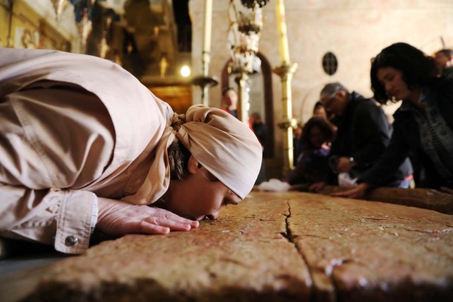 A worshipper kisses the Stone of Anointing, where Christians believe the body of Jesus was prepared for burial, in the Church of the Holy Sepulchre in JerusalemÕs Old City, February 28, 2018. REUTERS/Ammar Awad