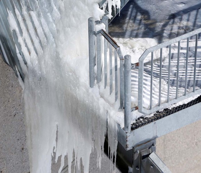 A frozen balustrade is pictured on top of the highest German mountain, the Zugspitze, in Garmisch-Partenkirchen, Germany February 28, 2018. REUTERS/Michaela Rehle