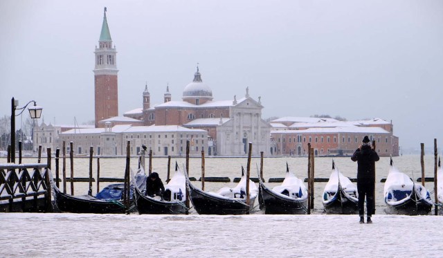 Snow covered gondola's are seen near St.Mark square in Venice lagoon, Italy, February 28, 2018. REUTERS/Manuel Silvestri