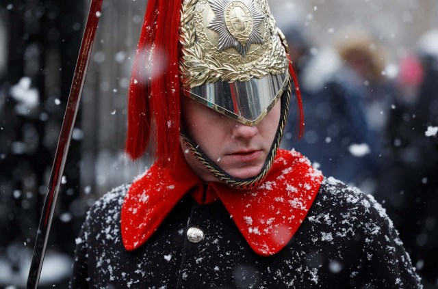 A guardsman stands on duty in the snow at Horse Guards Parade in London, February 28, 2018. REUTERS/Peter Nicholls