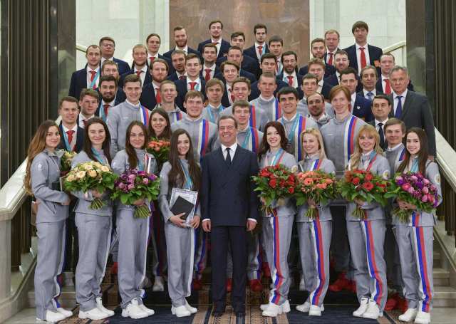 Russian Prime Minister Dmitry Medvedev, Russian athletes and officials pose for a picture during a ceremony to present cars to the prizewinners of the 2018 Pyeongchang Winter Olympic Games in Moscow, Russia February 28, 2018. Sputnik/Alexander Astafyev/Pool via REUTERS  ATTENTION EDITORS - THIS IMAGE WAS PROVIDED BY A THIRD PARTY.