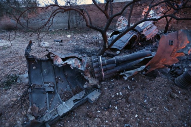 A picture taken on February 3, 2018, shows parts of a downed Sukhoi-25 fighter jet near the Syrian city of Saraqib, southwest of Aleppo. Rebel fighters shot down a Russian plane over Syria's northwest Idlib province and captured its pilot, the Syrian Observatory for Human Rights said. / AFP PHOTO / OMAR HAJ KADOUR