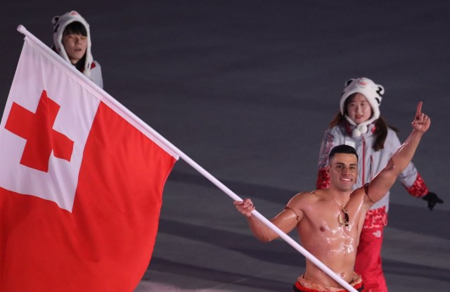 Pyeongchang 2018 Winter Olympics – Opening ceremony – Pyeongchang Olympic Stadium - Pyeongchang, South Korea – February 9, 2018 - Pita Taufatofua of Tonga carries the national flag. REUTERS/Carlos Barria