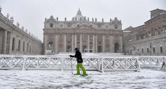 A man skis past St Peter's square covered in snow on February 26, 2018 at The Vatican / AFP PHOTO / TIZIANA FABI