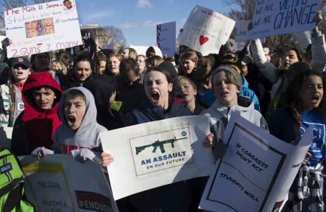 Thousands of local students protest as they rally during a nationwide student walkout for gun control in front the White House in Washington, DC, March 14, 2018. Students across the US walked out of classes on March 14, in a nationwide call for action against gun violence following the shooting deaths last month at a Florida high school. The nationwide protest is being held one month to the day after Nikolas Cruz, a troubled 19-year-old former student at Stoneman Douglas, unleashed a hail of gunfire on his former classmates. / AFP PHOTO / SAUL LOEB