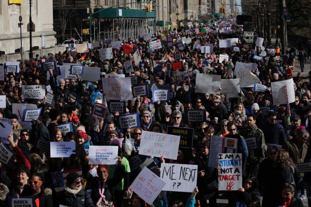 Participants take part in the March for Our Lives Rally in New York on March 24, 2018. Bundled against the cold but fired up with passion after a Florida high school massacre, crowds gathered in Washington on Saturday for what is expected to be the biggest US gun control protest in a generation, with hundreds of thousands attending.The student-organized protest is to feature rallies from coast to coast, with the main event in Washington within sight of the US Capitol -- whose lawmakers the protesters hope to influence. / AFP PHOTO