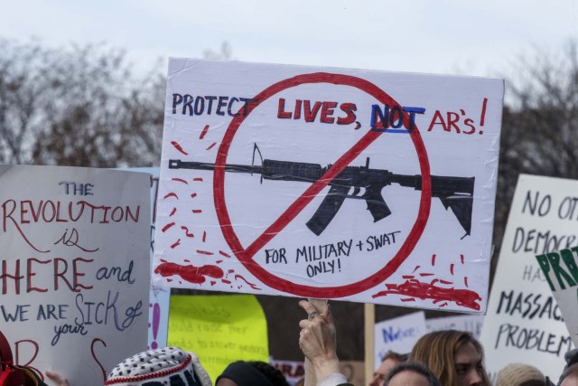 Rally goers carry protest signs during the March for Our Lives Rally in Washington, DC on March 24, 2018. Galvanized by a massacre at a Florida high school, hundreds of thousands of Americans are expected to take to the streets in cities across the United States on Saturday in the biggest protest for gun control in a generation. / AFP PHOTO / Alex Edelman