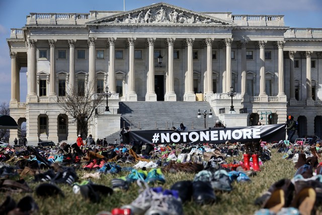 WASHINGTON, DC - MARCH 13: Seven thousand pairs of shoes, representing the children killed by gun violence since the mass shooting at Sandy Hook Elementary School in 2012, are spread out on the lawn on the east side of the U.S. Capitol March 13, 2018 in Washington, DC. Organized by the online activist group Avaaz, the shoes are intended to urge Congress to pass gun-reform legislation. Chip Somodevilla/Getty Images/AFP