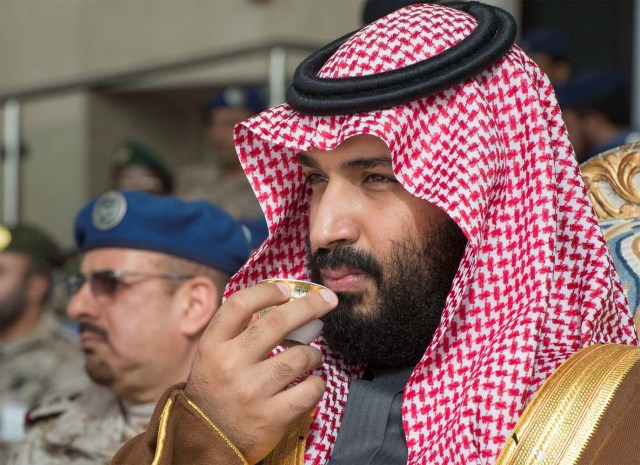Saudi Arabia's Crown Prince Mohammed bin Salman drinks coffee during the graduation ceremony of the 93rd batch of the cadets of King Faisal Air Academy, in Riyadh, Saudi Arabia, February 21, 2018. Bandar Algaloud/Courtesy of Saudi Royal Court/Handout via REUTERS ATTENTION EDITORS - THIS PICTURE WAS PROVIDED BY A THIRD PARTY.