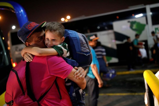 Josmer Rivas, 7, traveling by bus from Caracas to Guayaquil with his mother, embraces his father upon arrival at the bus station in Guayaquil, Ecuador, November 10, 2017. Carlos Garcia Rawlins: "Josmer's mother, Genesis Corro, told me that her husband would be waiting for them at the Guayaquil bus terminal and that her son was very excited to see his father, who moved there from Venezuela four months ago. As soon as we arrived, I hurriedly got off the bus so I could witness their reunion. Josmer ran out and jumped into his arms, happiness was overflowing from his eyes, undoubtedly one of the most emotional moments during the journey". REUTERS/Carlos Garcia Rawlins SEARCH "RAWLINS BUS" FOR THIS STORY. SEARCH "WIDER IMAGE" FOR ALL STORIES.