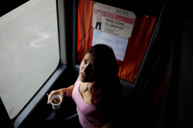 Karelys Betancourt, traveling by bus from Caracas to Chile, drinks a cup of tea while she recovers from motion sickness in Ocona, Peru, November 13, 2017. At this stage of the trip the group of Venezuelan migrants were traveling on the top floor of the bus, because it was cheaper, but the motion was stronger. When Karelys started to get sick, the bus hostess gave her tea without sugar and recommended that she should go and sit on the stairs in front of the bathroom to recover. REUTERS/Carlos Garcia Rawlins SEARCH "RAWLINS BUS" FOR THIS STORY. SEARCH "WIDER IMAGE" FOR ALL STORIES.