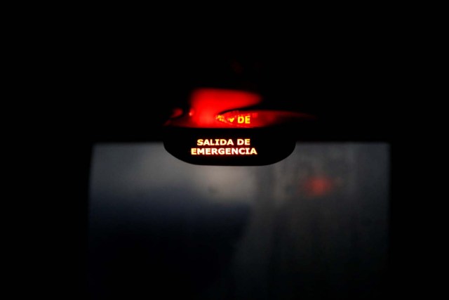 An emergency exit sign is lit up inside a bus in Chimbote, Peru, November 12, 2017. REUTERS/Carlos Garcia Rawlins SEARCH "RAWLINS BUS" FOR THIS STORY. SEARCH "WIDER IMAGE" FOR ALL STORIES.