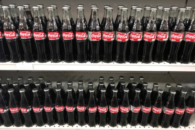 Bottles of Coca-Cola are seen on a shelf at a supermarket in Caracas, Venezuela March 7, 2018. Picture taken March 7, 2018. REUTERS/Marco Bello