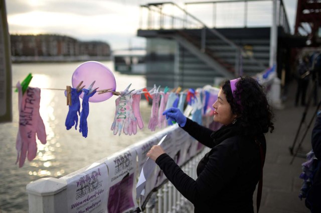 A protester hangs gloves with messages while taking part in a strike for women's rights in Portugalete, Spain, March 8, 2018, on International Women's Day. REUTERS/Vincent West