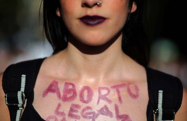 A woman shows the words "Legal abortion" written on her chest during a demonstration on International Women's Day in Buenos Aires, Argentina, March 8, 2018. REUTERS/Marcos Brindicci