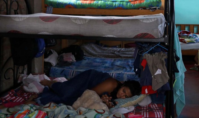 A Venezuelan migrant sleeps in a room at a shelter for Venezuelans in San Juan de Lurigancho, on the outskirts of Lima, Peru March 9, 2018. REUTERS/Mariana Bazo