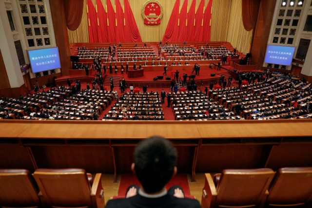 Delegates cast ballots during a vote on a constitutional amendment lifting presidential term limits, at the third plenary session of the National People's Congress (NPC) at the Great Hall of the People in Beijing, China March 11, 2018. REUTERS/Damir Sagolj
