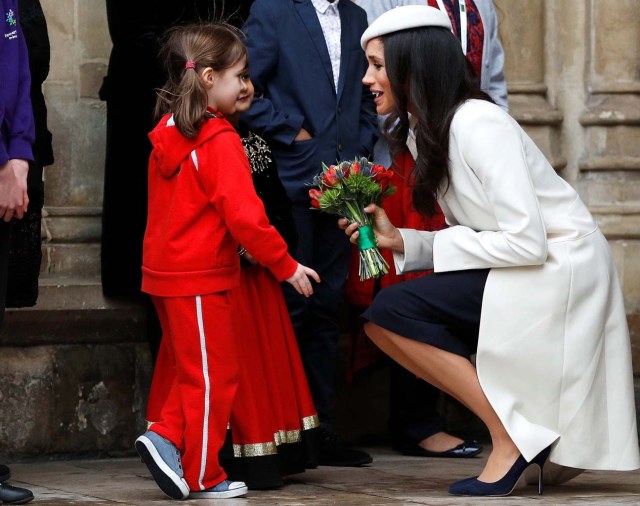 Britain's Prince Harry's fiancee Meghan Markle receives a bouquet of flowers after attending the Commonwealth Service at Westminster Abbey in London, Britain, March 12, 2018. REUTERS/Peter Nicholls