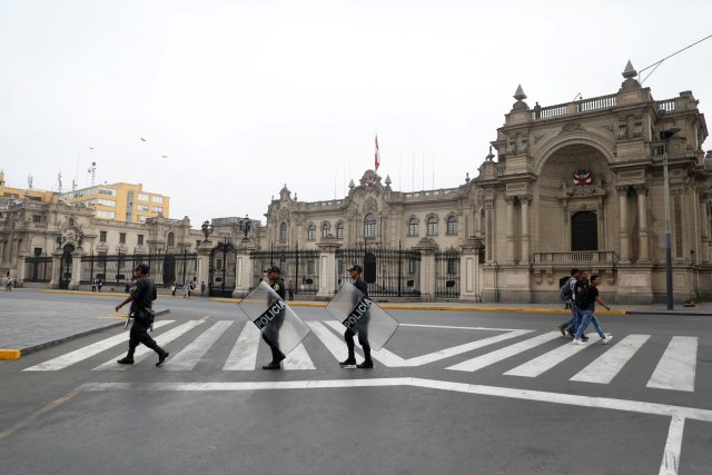 Peruvian police patrol near the Government Palace in Lima, Peru March 21, 2018. REUTERS/Guadalupe Pardo