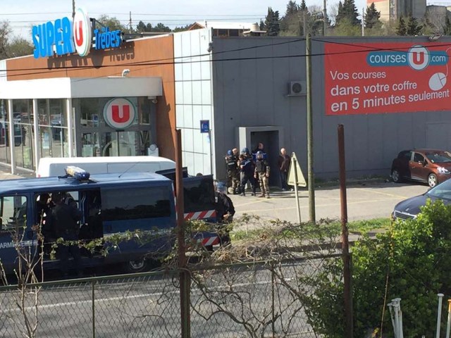 Police are seen at the scene of a hostage situation in a supermarket in Trebes, Aude, France March 23, 2018 in this picture obtained from a social media video. LA VIE A TREBES/via REUTERS ATTENTION EDITORS - THIS IMAGE WAS PROVIDED BY A THIRD PARTY. NO RESALES. NO ARCHIVES. MANDATORY CREDIT.