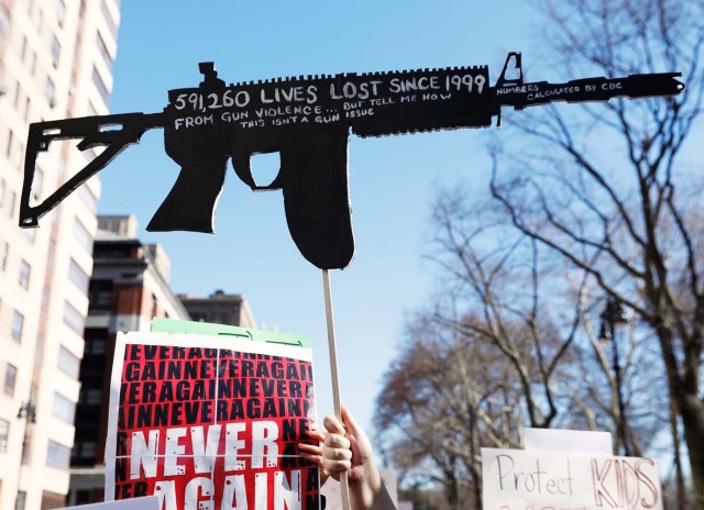 Protesters raise signs during a "March For Our Lives" demonstration demanding gun control in New York City, U.S. March 24, 2018. REUTERS/Shannon Stapleton