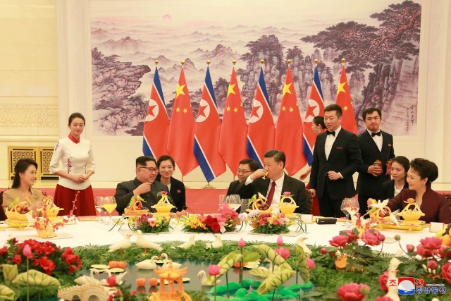 REFILE - ADDING CITY North Korean leader Kim Jong Un and wife Ri Sol Ju, and Chinese President Xi Jinping and wife Peng Liyuan toast each other, as Kim Jong Un paid an unofficial visit to Beijing, China, in this undated photo released by North Korea's Korean Central News Agency (KCNA) in Pyongyang March 28, 2018. KCNA/via Reuters ATTENTION EDITORS - THIS IMAGE WAS PROVIDED BY A THIRD PARTY. REUTERS IS UNABLE TO INDEPENDENTLY VERIFY THIS IMAGE. NO THIRD PARTY SALES. NOT FOR USE BY REUTERS THIRD PARTY DISTRIBUTORS. SOUTH KOREA OUT. NO COMMERCIAL OR EDITORIAL SALES IN SOUTH KOREA.
