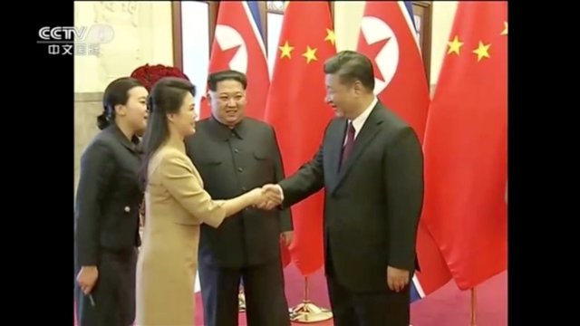 REFILE - ADDING CITY North Korean leader Kim Jong Un watches as his wife Ri Sol Ju shakes hands with Chinese President Xi Jinping, in this still image taken from video released on March 28, 2018. North Korean leader Kim Jong Un visited Beijing, China from Sunday to Wednesday on an unofficial visit, China's state news agency Xinhua reported on Wednesday. CCTV via Reuters TV ATTENTION EDITORS - NO RESALES. NO ARCHIVES. CHINA OUT.