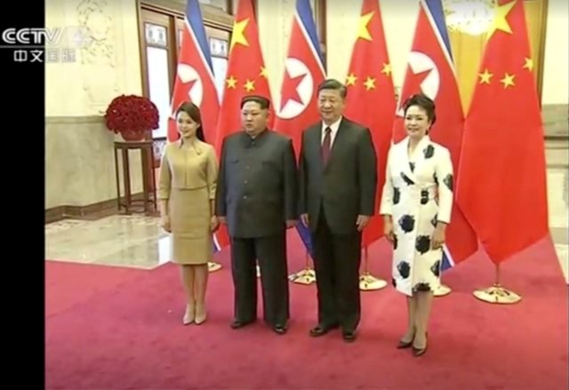 REFILE - ADDING CITY North Korean leader Kim Jong Un and his wife Ri Sol Ju pose for a photo with Chinese President Xi Jinping and his wife Peng Liyuan, in this still image taken from video released on March 28, 2018. North Korean leader Kim Jong Un visited Beijing, China, from Sunday to Wednesday on an unofficial visit, China's state news agency Xinhua reported on Wednesday. CCTV via Reuters TV ATTENTION EDITORS - NO RESALES. NO ARCHIVES. CHINA OUT.