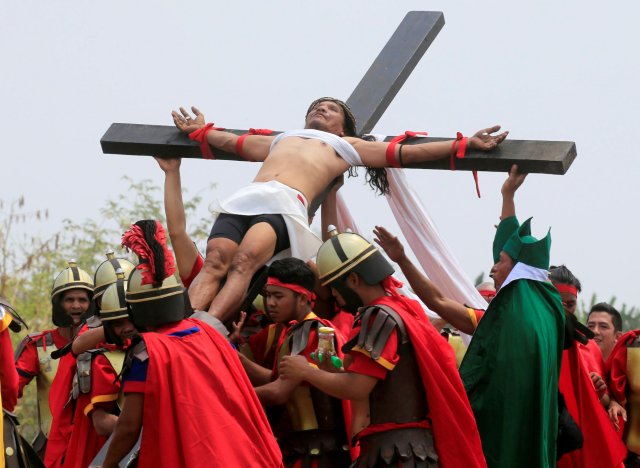 Ruben Enaje, 58, who is portraying Jesus Christ for the 32nd time, is nailed on a wooden cross during a Good Friday crucifixion re-enactment in Cutud village, Pampanga province, north of Manila, Philippines March 30, 2018. REUTERS/Romeo Ranoco