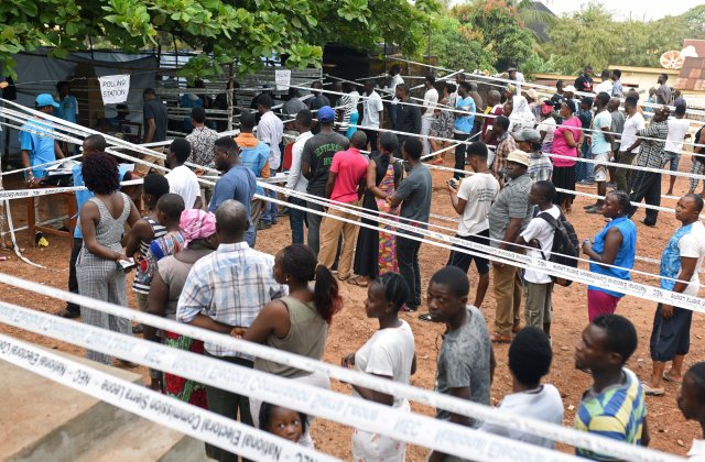 People queue to cast their vote at a polling station during a presidential run-off in Freetown, Sierra Leone March 31, 2018. REUTERS/Olivia Acland