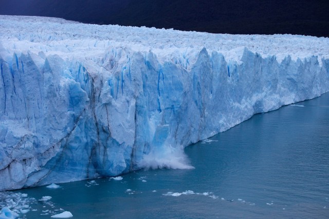 A chunck of ice falls from the Perito Moreno Glacier, at Los Glaciares National Park, near El Calafate in the Argentine province of Santa Cruz, on March 10, 2018. An arch of ice formed at the tip of the Perito Moreno, between the glacier and the shore of Argentino lake, started collapsing into the water on Saturday, a natural display that happens just once every several years. Such arches form roughly every two to four years, when the glacier forms a dam of ice that cuts off the flow of water around it into the lake -- until the water breaks through, opening up a steadily wider tunnel that eventually becomes a narrow arch... and then collapses. / AFP PHOTO / Walter Diaz