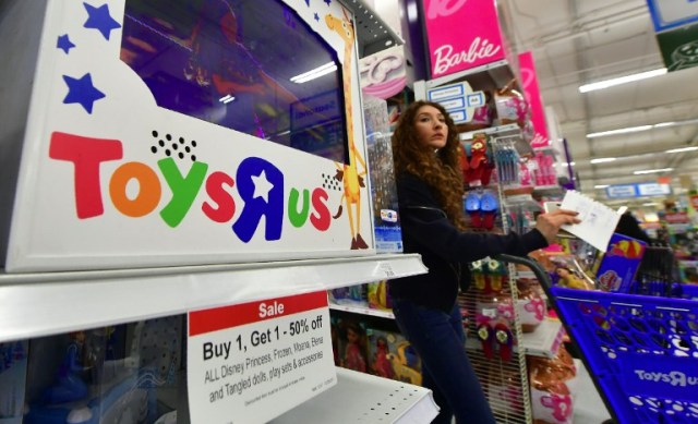 (FILES) This file photo taken on December 19, 2017 shows a woman shopping at a Toys R Us store in Alhambra, California. Toys 'R' US plans to sell or close all of its US stores, potentially hitting 33,000 jobs, US media reported on March 14, 2018. / AFP PHOTO / FREDERIC J. BROWN