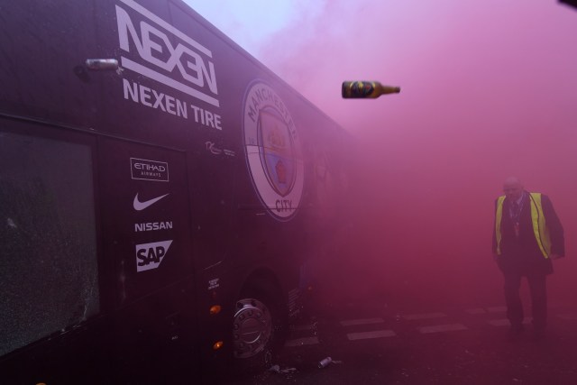 Bottles and cans are thrown at the bus as Manchester City players arrive at the stadium before the UEFA Champions League first leg quarter-final football match between Liverpool and Manchester City, at Anfield stadium in Liverpool, north west England on April 4, 2018. / AFP PHOTO / Paul ELLIS