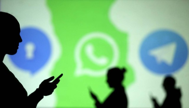 REFILE - CLARIFYING CAPTION Silhouettes of mobile users are seen next to logos of social media apps Signal, Whatsapp and Telegram projected on a screen in this picture illustration taken March 28, 2018.  REUTERS/Dado Ruvic/Illustration