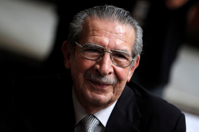 FILE PHOTO: Former Guatemalan dictator Efrain Rios Montt smiles during his genocide trial, which is drawing to a conclusion, at the Supreme Court of Justice in Guatemala City, Guatemala May 8, 2013. REUTERS/Jorge Dan Lopez/File Photo